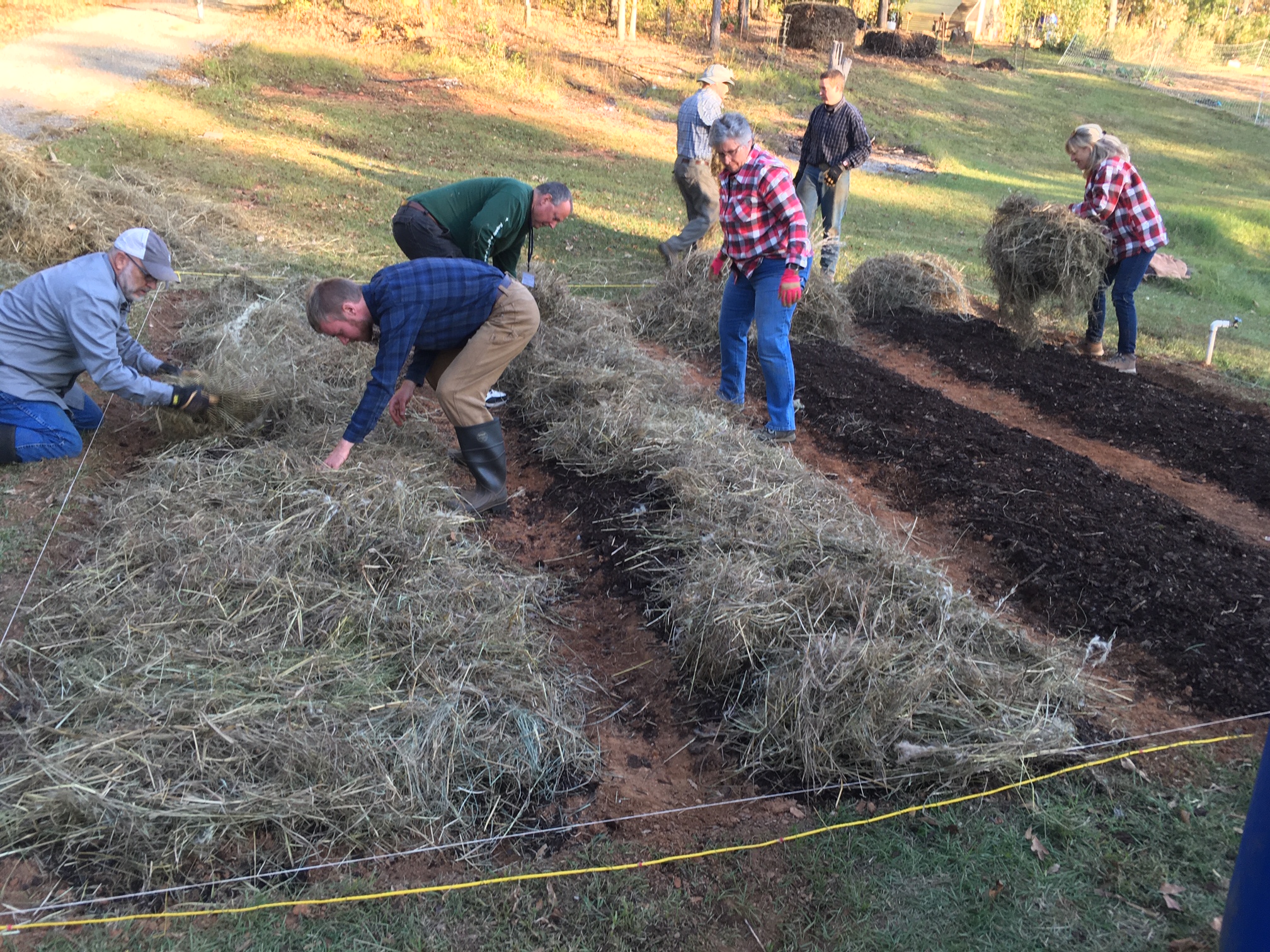 Volunteers mulching garden beds