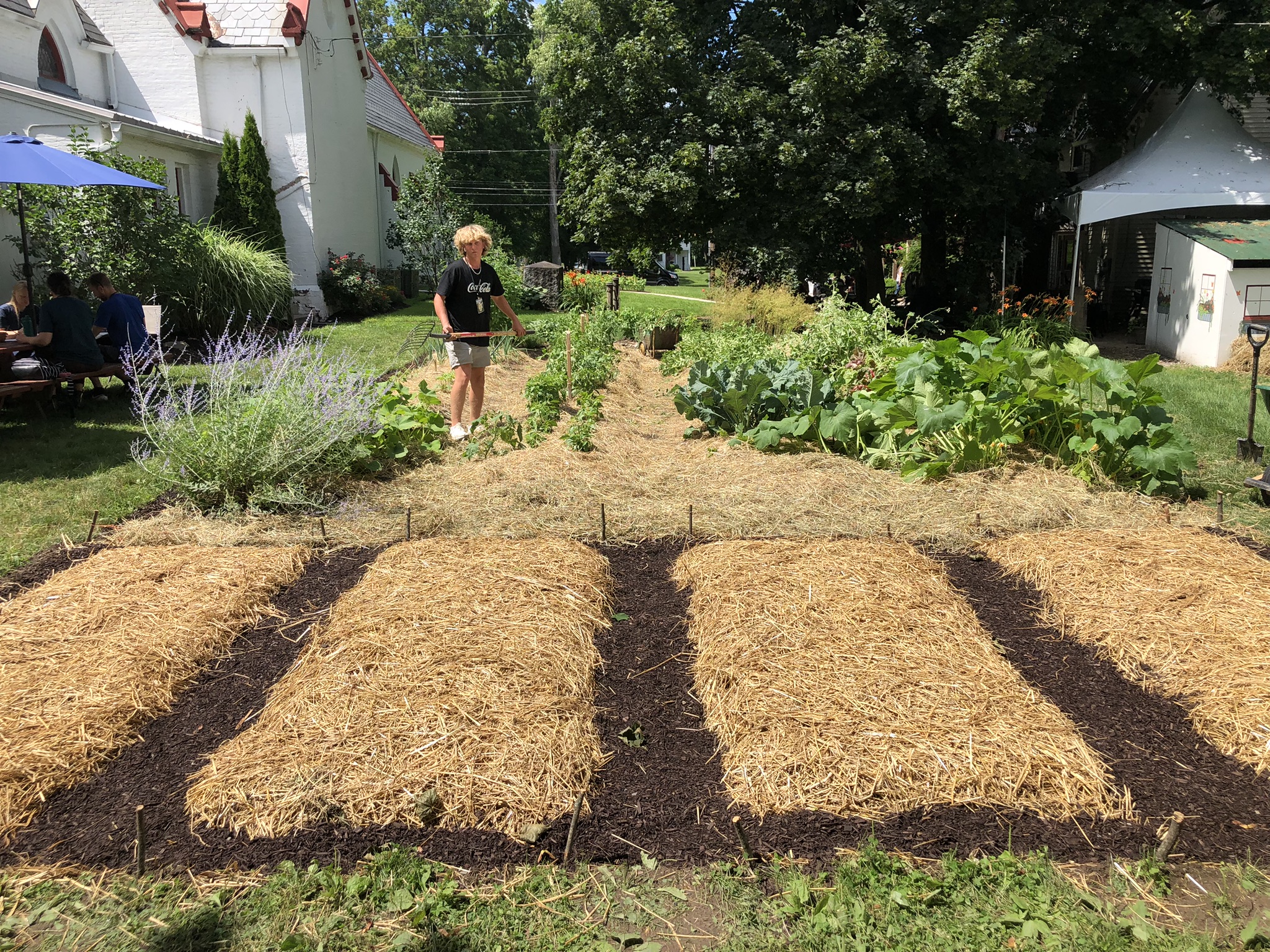 A thriving community Well-Watered Garden next to a church
